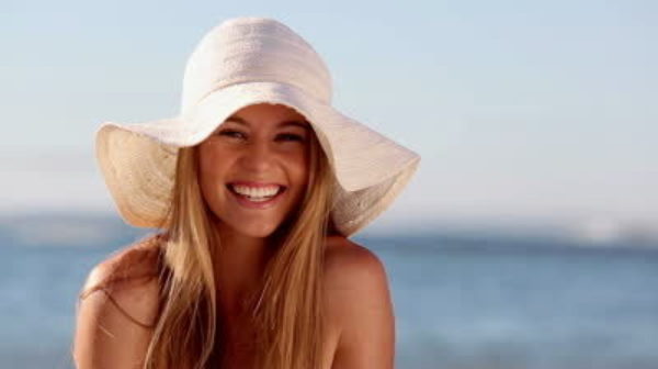A lady smiling at the beach